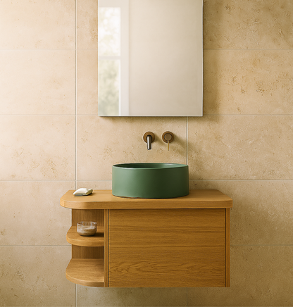 Bathroom vanity with green sink and wooden cabinet against a beige tiled wall.